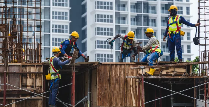 Construction workers working on a high-rise building in Kuala Lumpur, Malaysia. @ Shutterstock