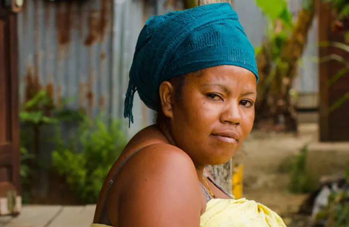 Starring woman with blue turban headband