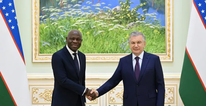 ILO Director-General Gilbert F. Houngbo (left) shakes hands with Uzbek President Shavkat Mirziyoyev (right)