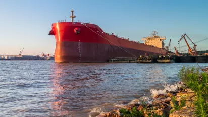 Red cargo container ship at harbor