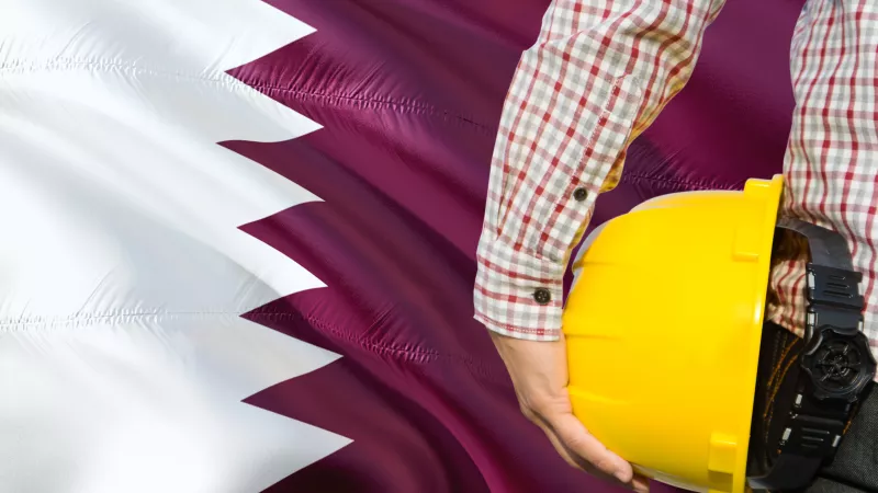 Qatari flag and safety helmet